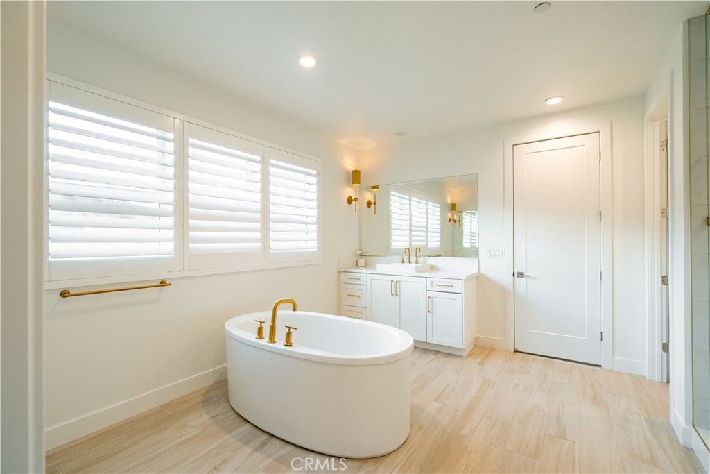 20043 Mersey Lane Porter Ranch, CA 91326 - Photo 40 of 68 a bathroom with a tub sink and mirror