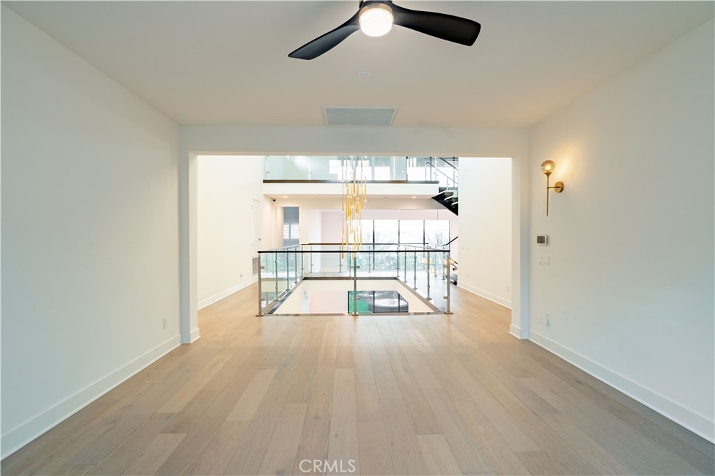 20043 Mersey Lane Porter Ranch, CA 91326 - Photo 49 of 68 an empty room with wooden floor fan and windows
