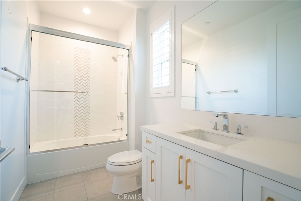20043 Mersey Lane Porter Ranch, CA 91326 - Photo 56 of 68 a bathroom with a shower sink vanity mirror and toilet