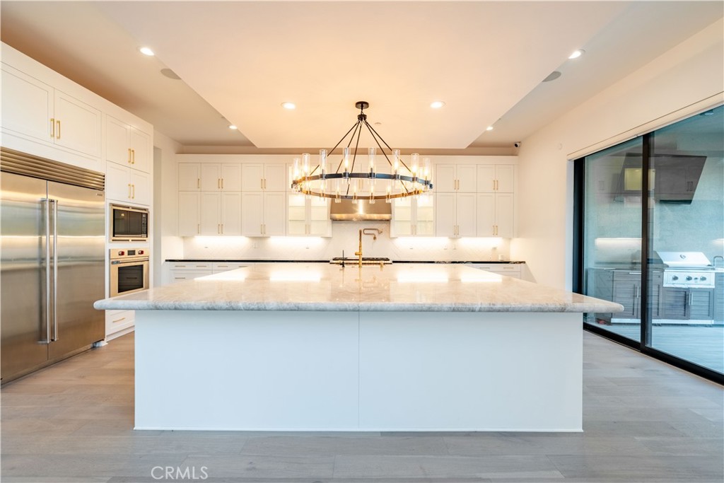 20043 Mersey Lane Porter Ranch, CA 91326 - Photo 9 of 68 a kitchen with stainless steel appliances granite countertop a sink and a refrigerator