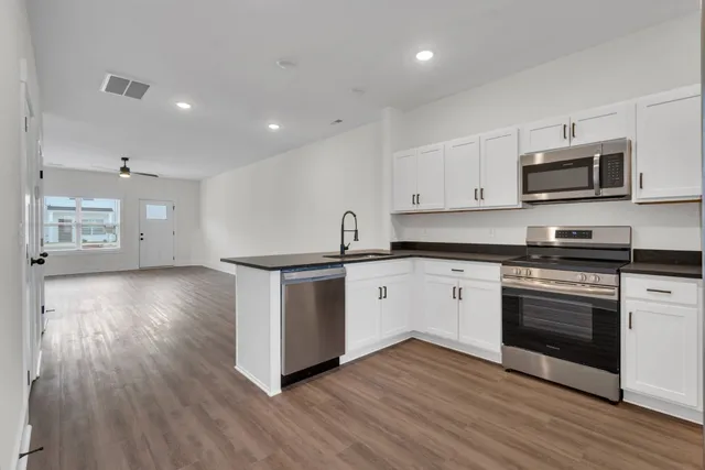 a kitchen with stainless steel appliances granite countertop a sink and cabinets