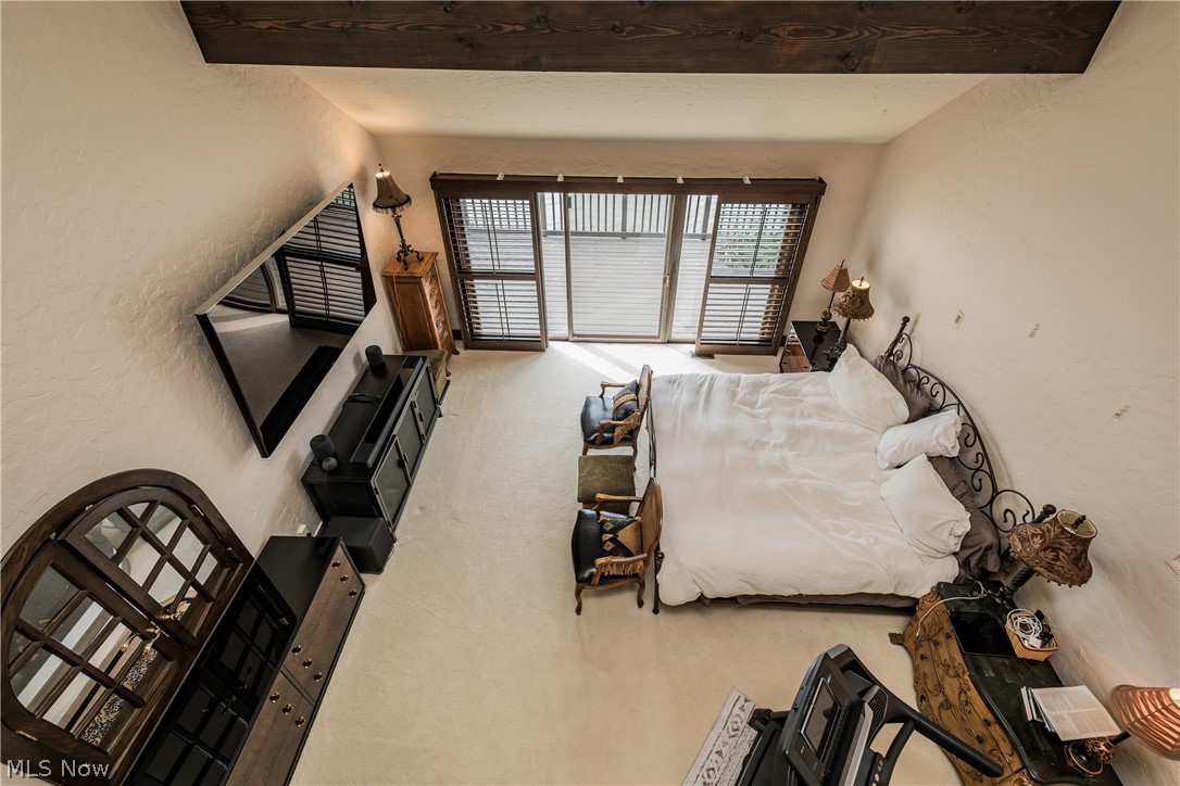 1415 Harbor Drive Northwest Canton, OH 44708 - Photo 25 of 46 Vaulted Owners Bedroom featuring carpet and sliding doors to second floor deck
