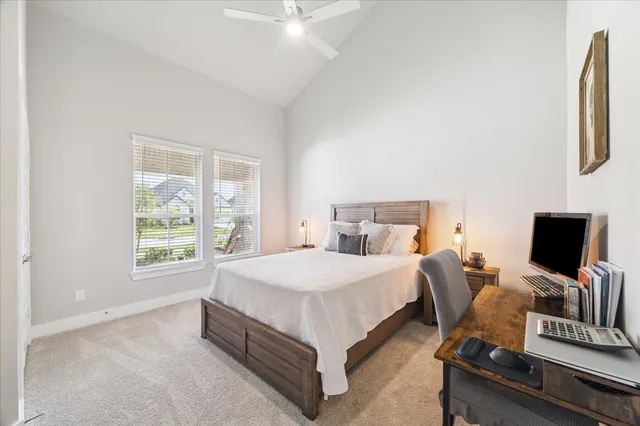 a spacious bedroom with a bed and a flat screen tv