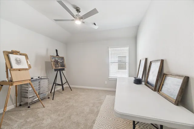 a view of a livingroom with furniture and a ceiling fan