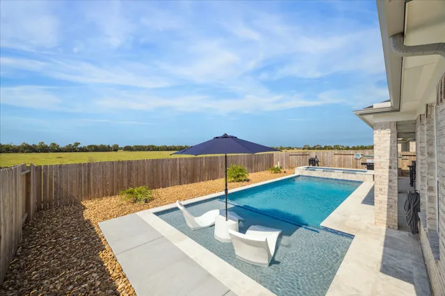swimming pool view with a lake view