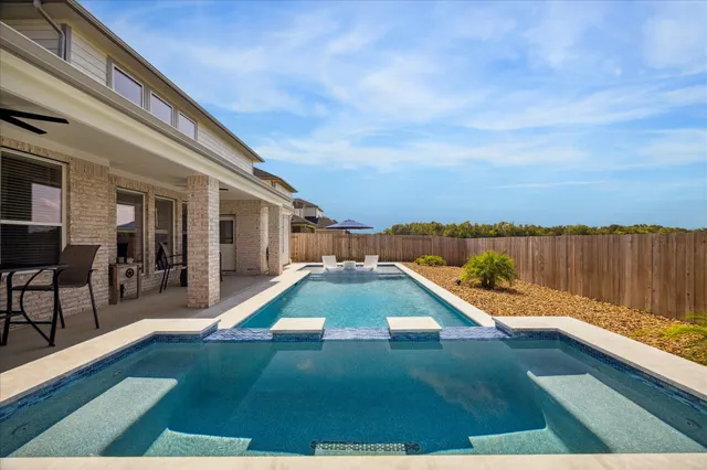 a view of swimming pool with lounge chair
