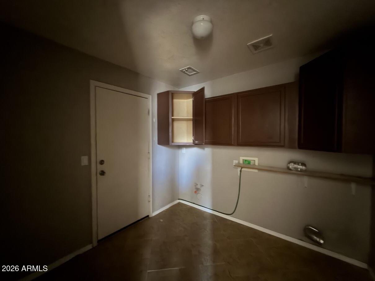 10807 West Monte Vista Road Avondale, AZ 85392 - Photo 18 of 33 an empty room with wooden floor and cabinet