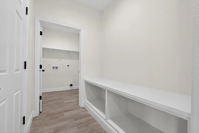 a view of hallway with wooden floor