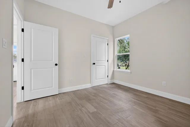 wooden floor in an empty room with a window