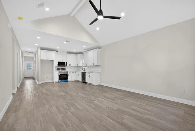 a view of kitchen with refrigerator microwave and stove