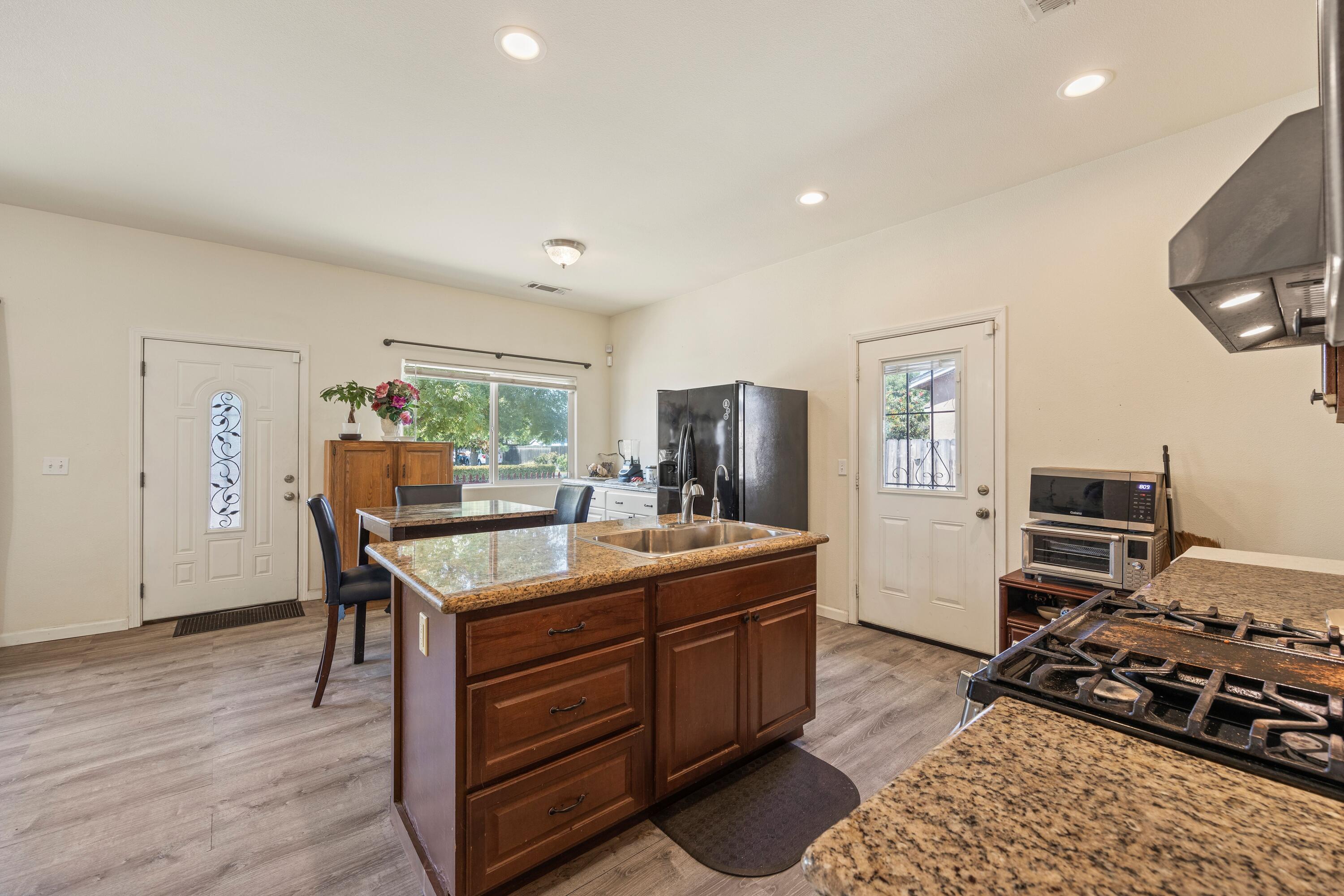 1052 South Klein Avenue Reedley, CA 93654 - Photo 3 of 10 a room with furniture a flat screen tv and a window