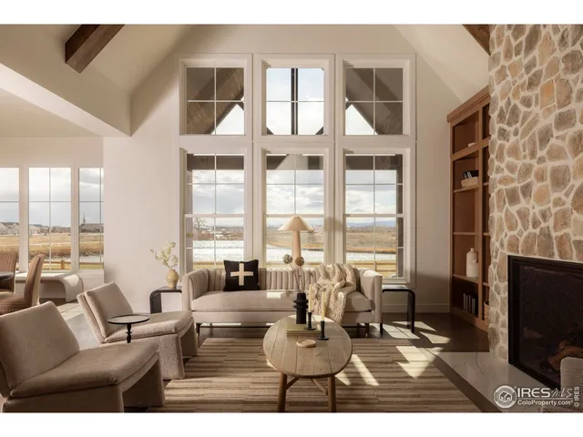 a living room with furniture a large window and a flat screen tv