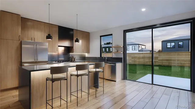 a kitchen with stainless steel appliances granite countertop a refrigerator a sink and a stove top oven