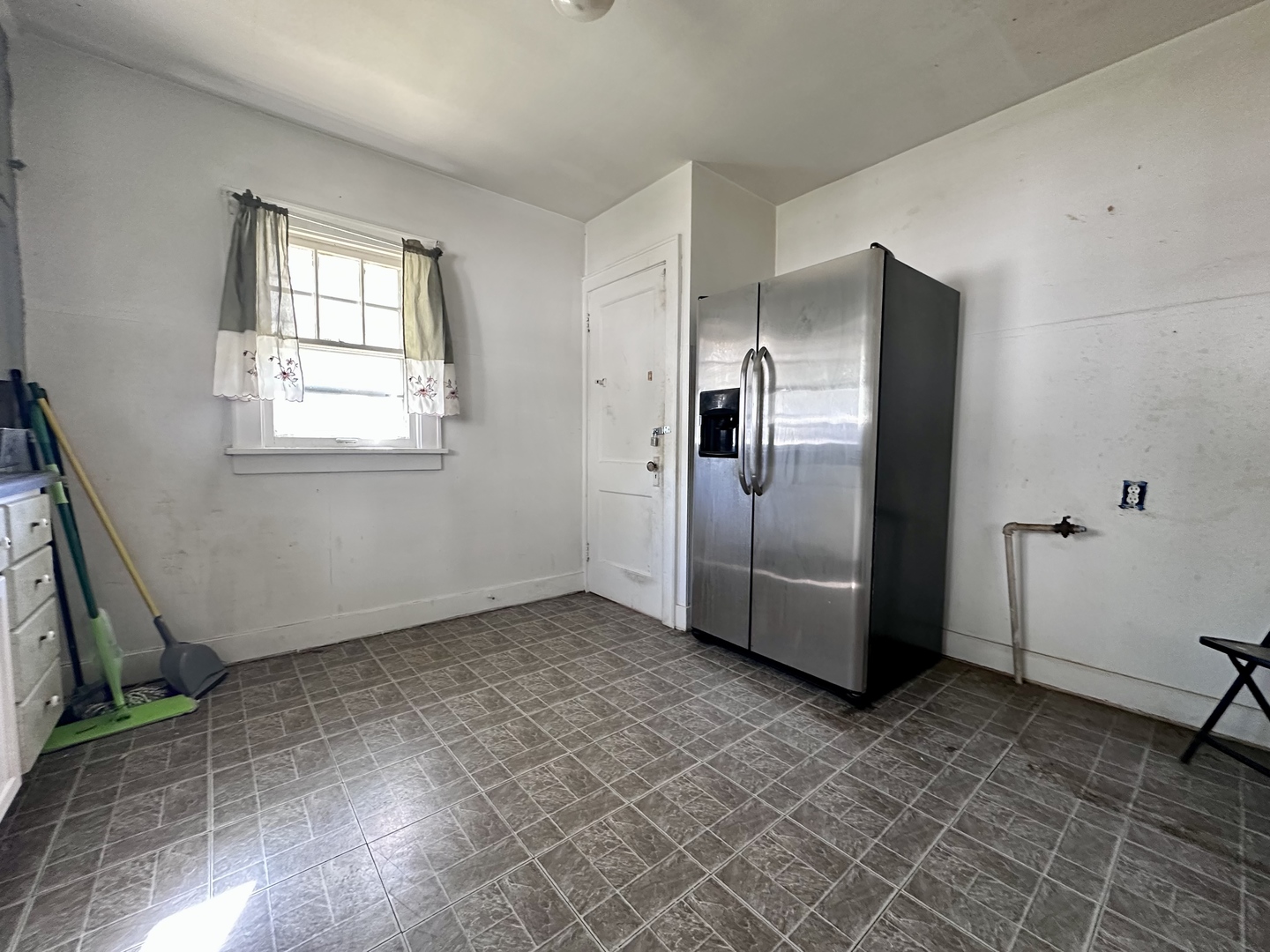 507 West 12th Street Sterling, IL 61081 - Photo 7 of 14 a view of a refrigerator in kitchen and an empty room
