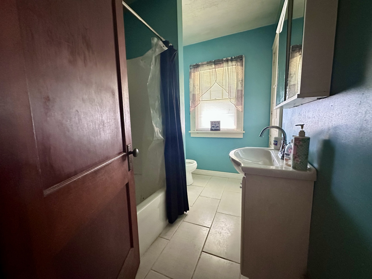 507 West 12th Street Sterling, IL 61081 - Photo 9 of 14 a bathroom with a granite countertop sink and a mirror