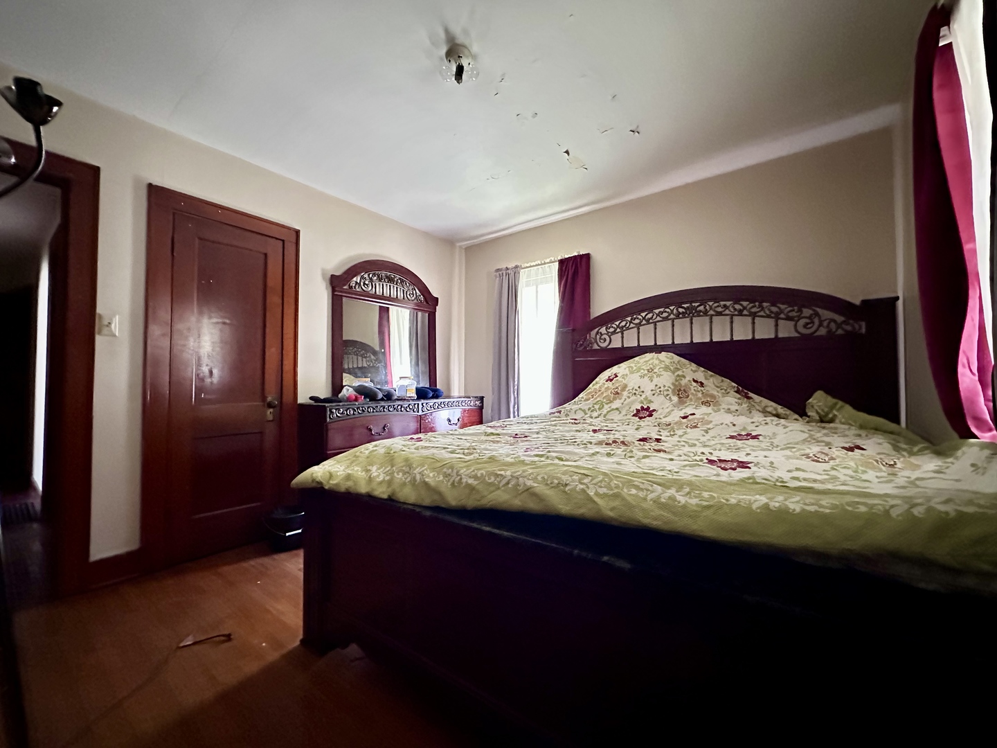 507 West 12th Street Sterling, IL 61081 - Photo 10 of 14 a bed sitting in a bedroom next to a window