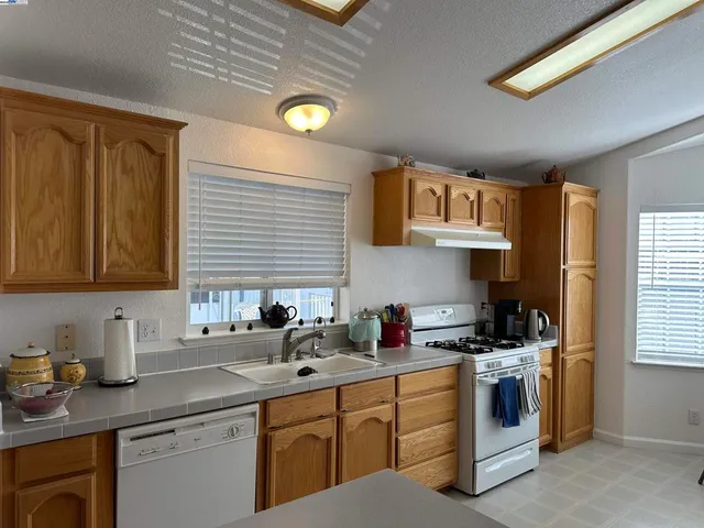 a dining room with furniture a window and kitchen view
