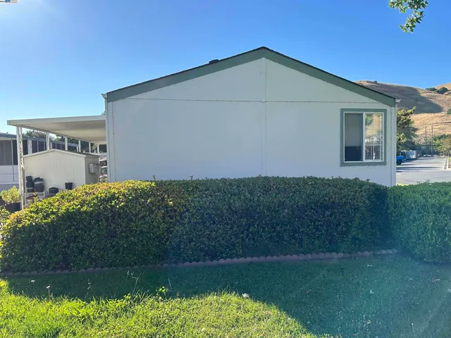 a view of a balcony with chair and potted plants