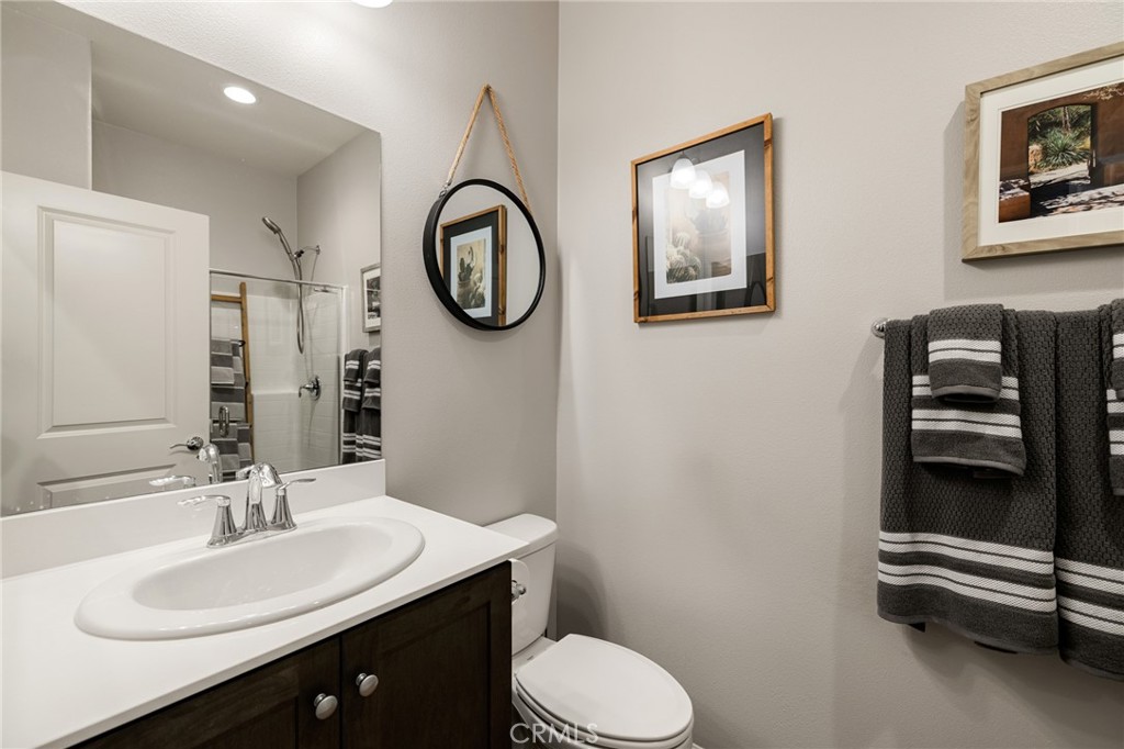 29981 Western Front Drive Menifee, CA 92584 - Photo 17 of 74 a bathroom with a sink mirror and toilet