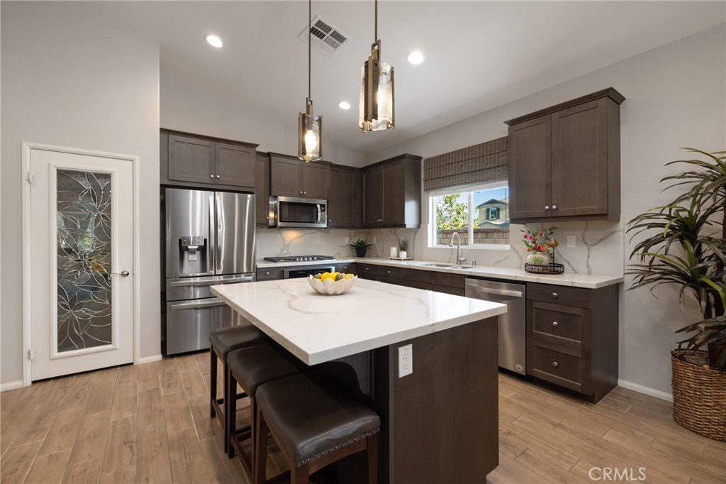 29981 Western Front Drive Menifee, CA 92584 - Photo 20 of 74 a kitchen with a stove a refrigerator and a sink