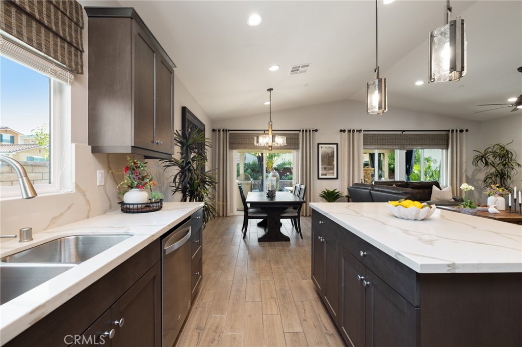 29981 Western Front Drive Menifee, CA 92584 - Photo 25 of 74 a kitchen with a sink a counter top space and living room view