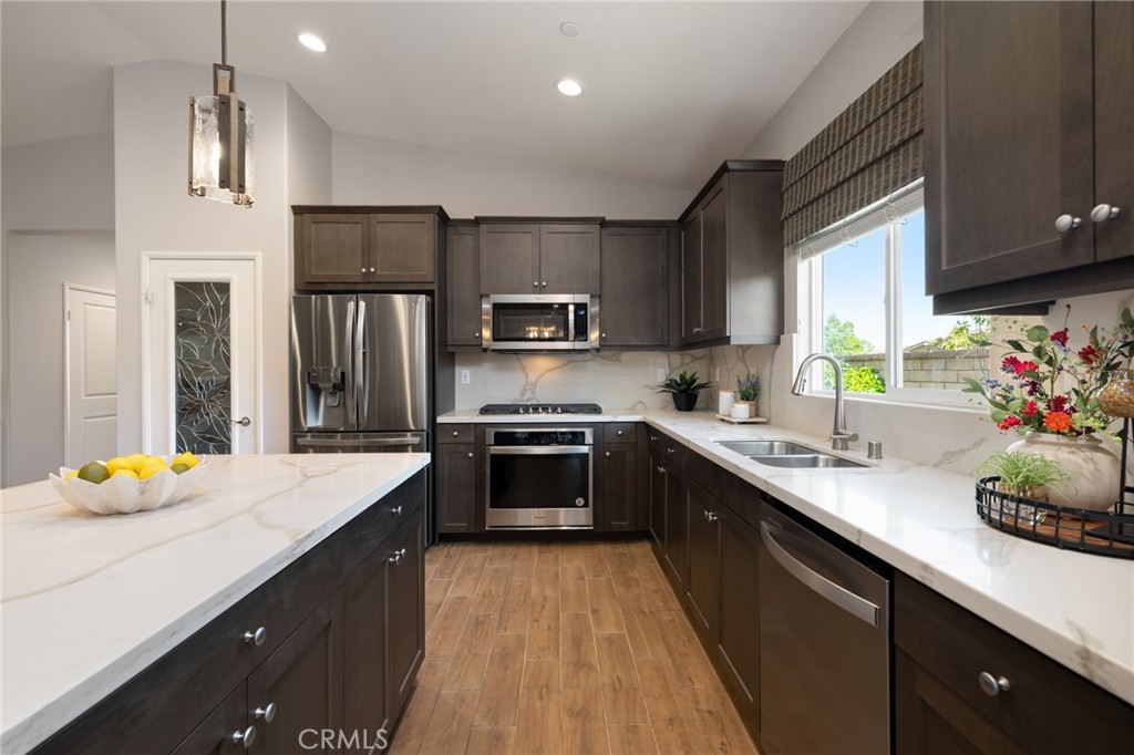 29981 Western Front Drive Menifee, CA 92584 - Photo 26 of 74 a kitchen with stainless steel appliances kitchen island granite countertop a sink stove and refrigerator