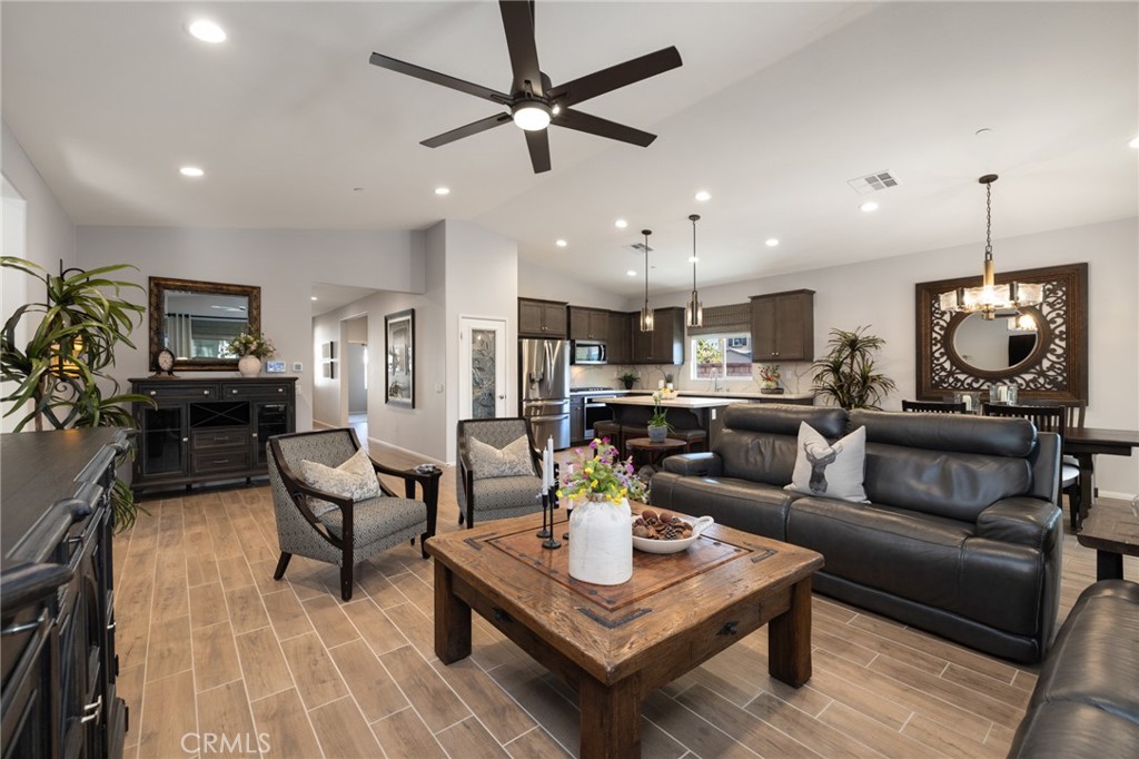 29981 Western Front Drive Menifee, CA 92584 - Photo 31 of 74 a living room with furniture kitchen view and a chandelier