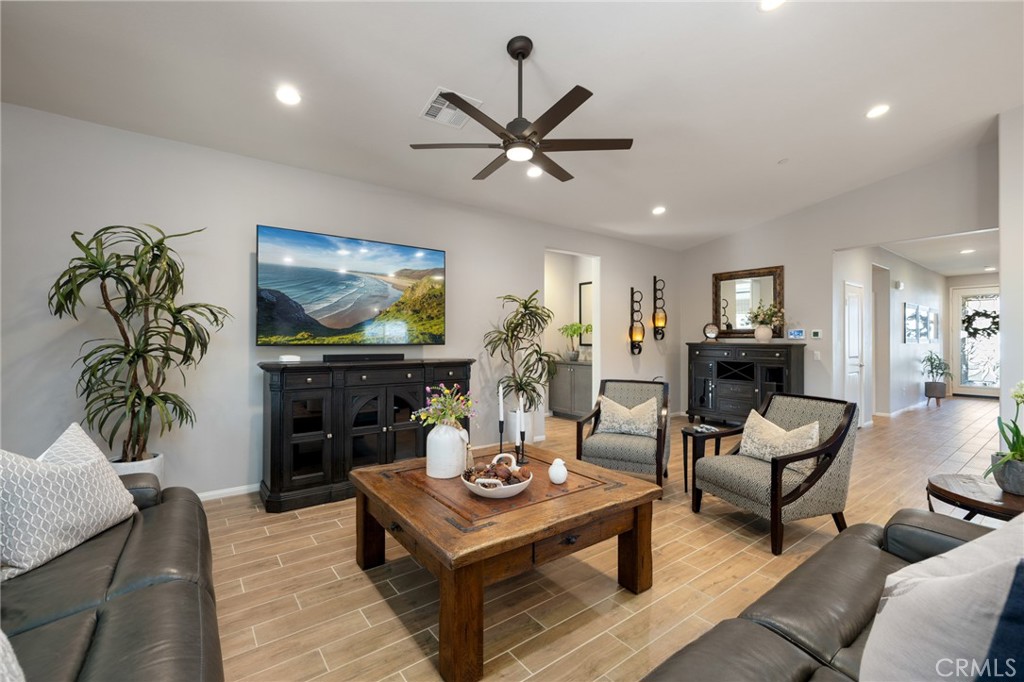 29981 Western Front Drive Menifee, CA 92584 - Photo 32 of 74 a living room with furniture a chandelier and a flat screen tv