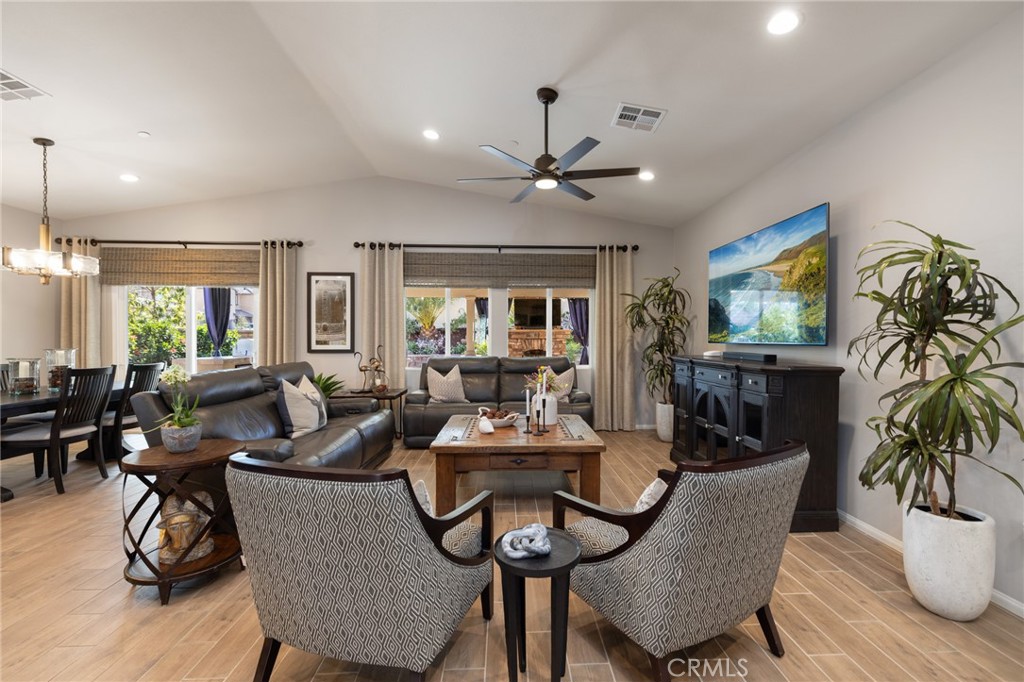 29981 Western Front Drive Menifee, CA 92584 - Photo 34 of 74 a dining room with furniture potted plants and wooden floor