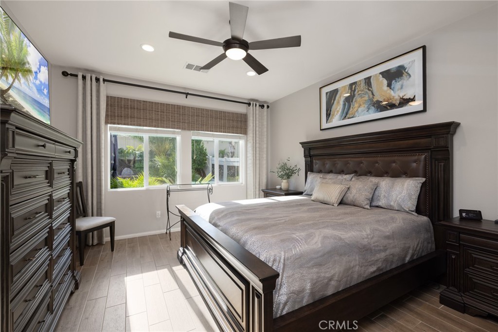 29981 Western Front Drive Menifee, CA 92584 - Photo 37 of 74 a bedroom with a large bed couch and a window