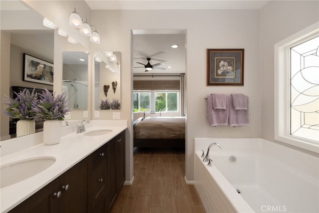 29981 Western Front Drive Menifee, CA 92584 - Photo 41 of 74 a en suite spacious bathroom with a tub double sink and a mirror