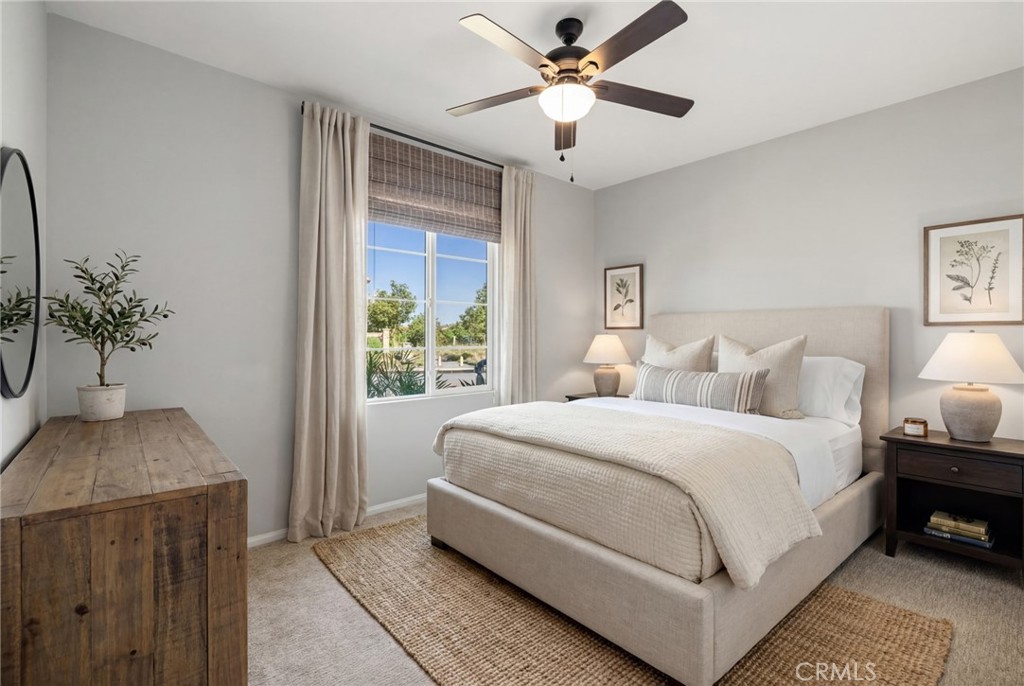 29981 Western Front Drive Menifee, CA 92584 - Photo 8 of 74 a spacious bedroom with a large bed and a chandelier