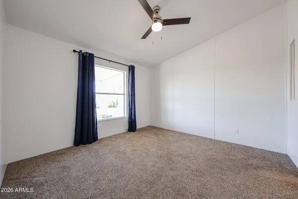 a view of empty room with ceiling fan