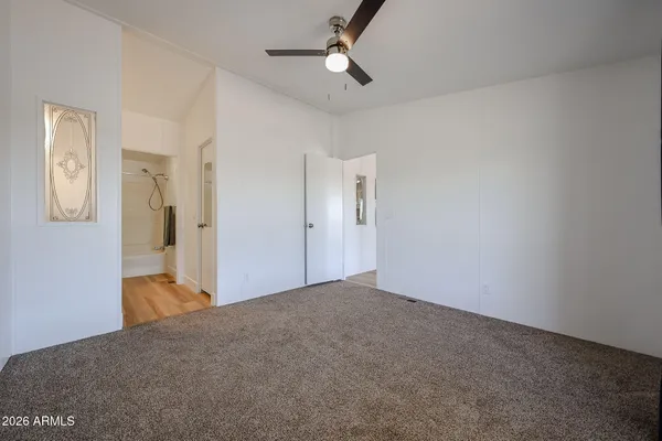 a view of empty room with ceiling fan