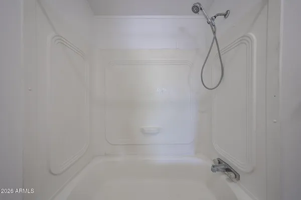 a bathroom with a bathtub and shower