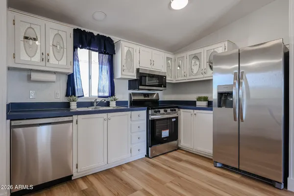 a kitchen with stainless steel appliances granite countertop a stove a sink and a refrigerator
