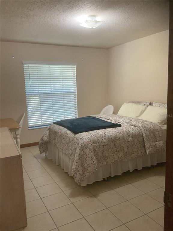 17005 Arrowhead Boulevard Winter Garden, FL 34787 - Photo 12 of 53 a bedroom with a bed and a window