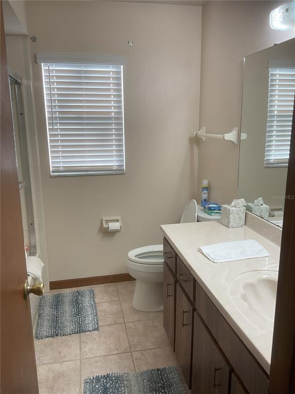 17005 Arrowhead Boulevard Winter Garden, FL 34787 - Photo 15 of 53 a bathroom with a granite countertop sink toilet a mirror and bathtub