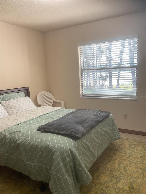 17005 Arrowhead Boulevard Winter Garden, FL 34787 - Photo 17 of 53 a bedroom with a bed and window