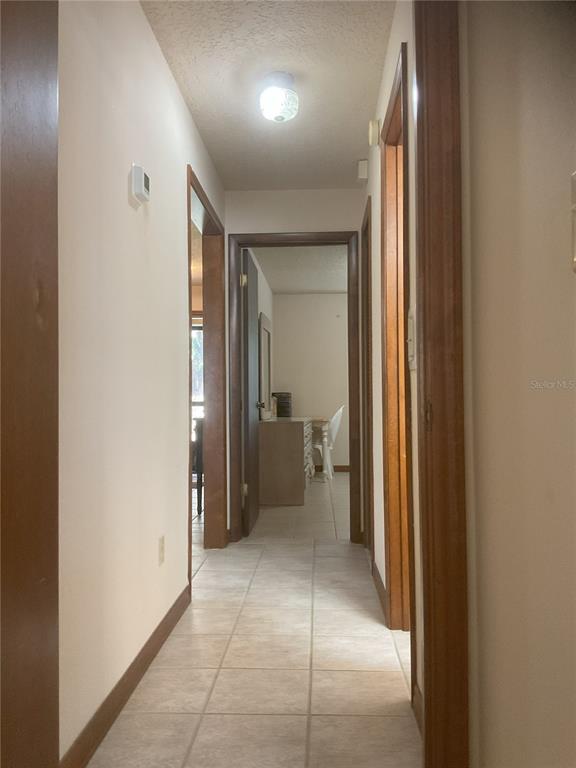 17005 Arrowhead Boulevard Winter Garden, FL 34787 - Photo 19 of 53 a view of a hallway with a livingroom and a bathroom