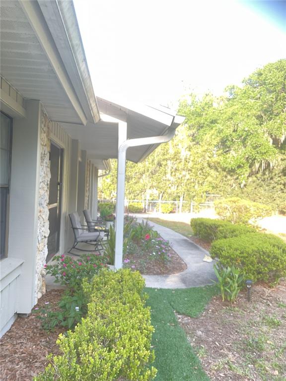 17005 Arrowhead Boulevard Winter Garden, FL 34787 - Photo 49 of 53 a view of a porch and garden