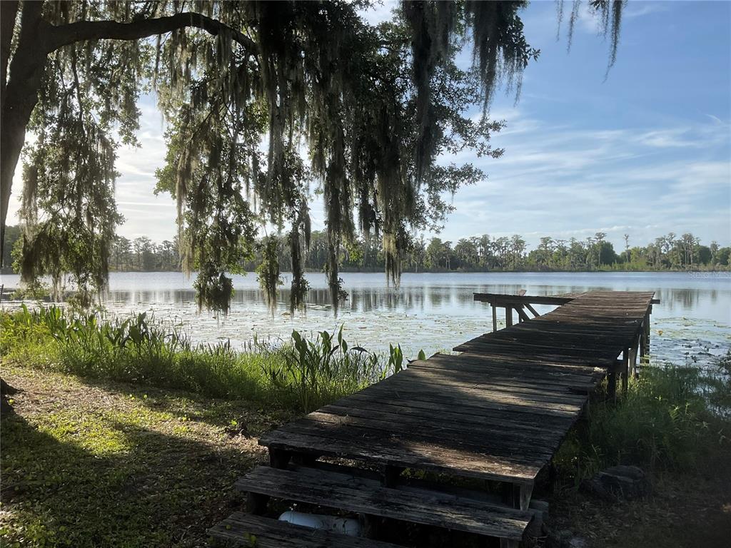 17005 Arrowhead Boulevard Winter Garden, FL 34787 - Photo 52 of 53 a lake view with a bench next to a lake