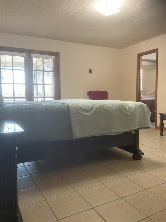 17005 Arrowhead Boulevard Winter Garden, FL 34787 - Photo 7 of 53 a bed sitting in a bedroom next to a window