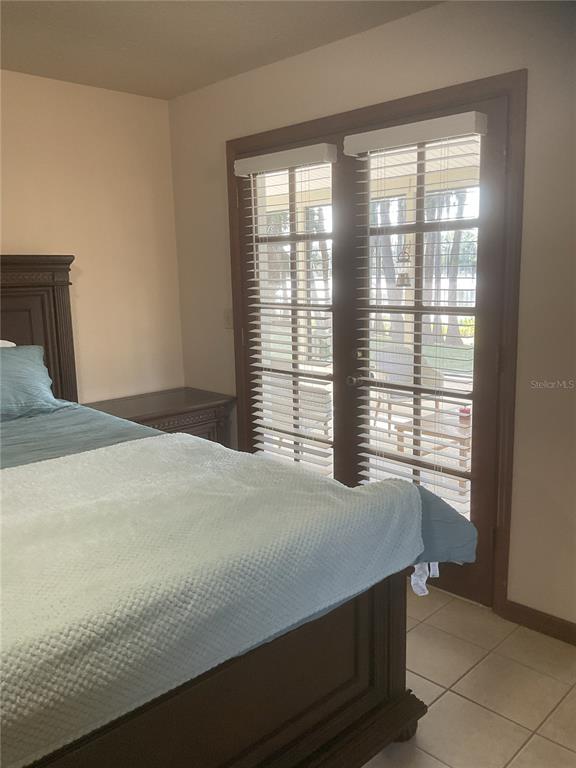 17005 Arrowhead Boulevard Winter Garden, FL 34787 - Photo 8 of 53 a bedroom with a bed and a window