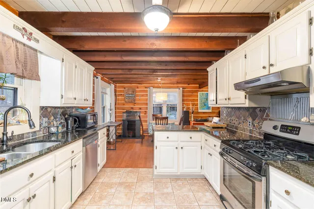 a kitchen with stainless steel appliances granite countertop a stove sink and cabinets