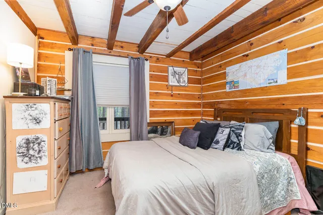 a bedroom with a bed and a large window with outer view