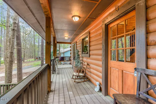 a view of a balcony with chairs and wooden floor