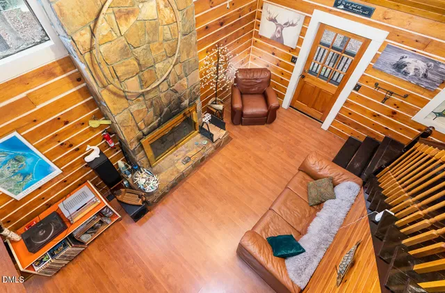 a backyard of a house with wooden floor and fence of a building