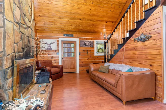 a living room with furniture and stairs