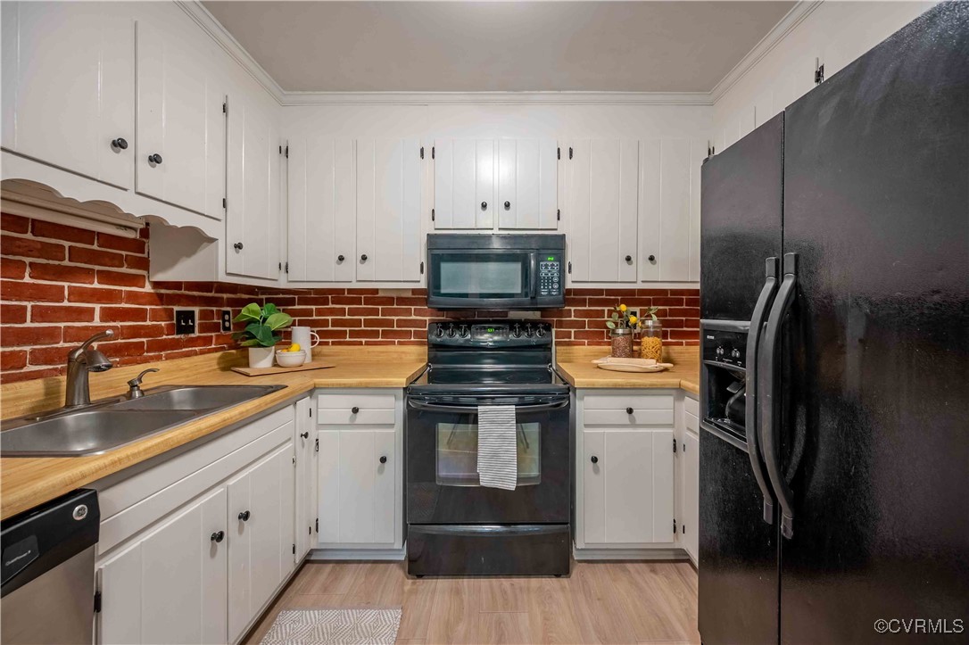 10313 Natural Bridge Road North Chesterfield, VA 23236 - Photo 11 of 31 a kitchen with stainless steel appliances a stove a refrigerator and a sink